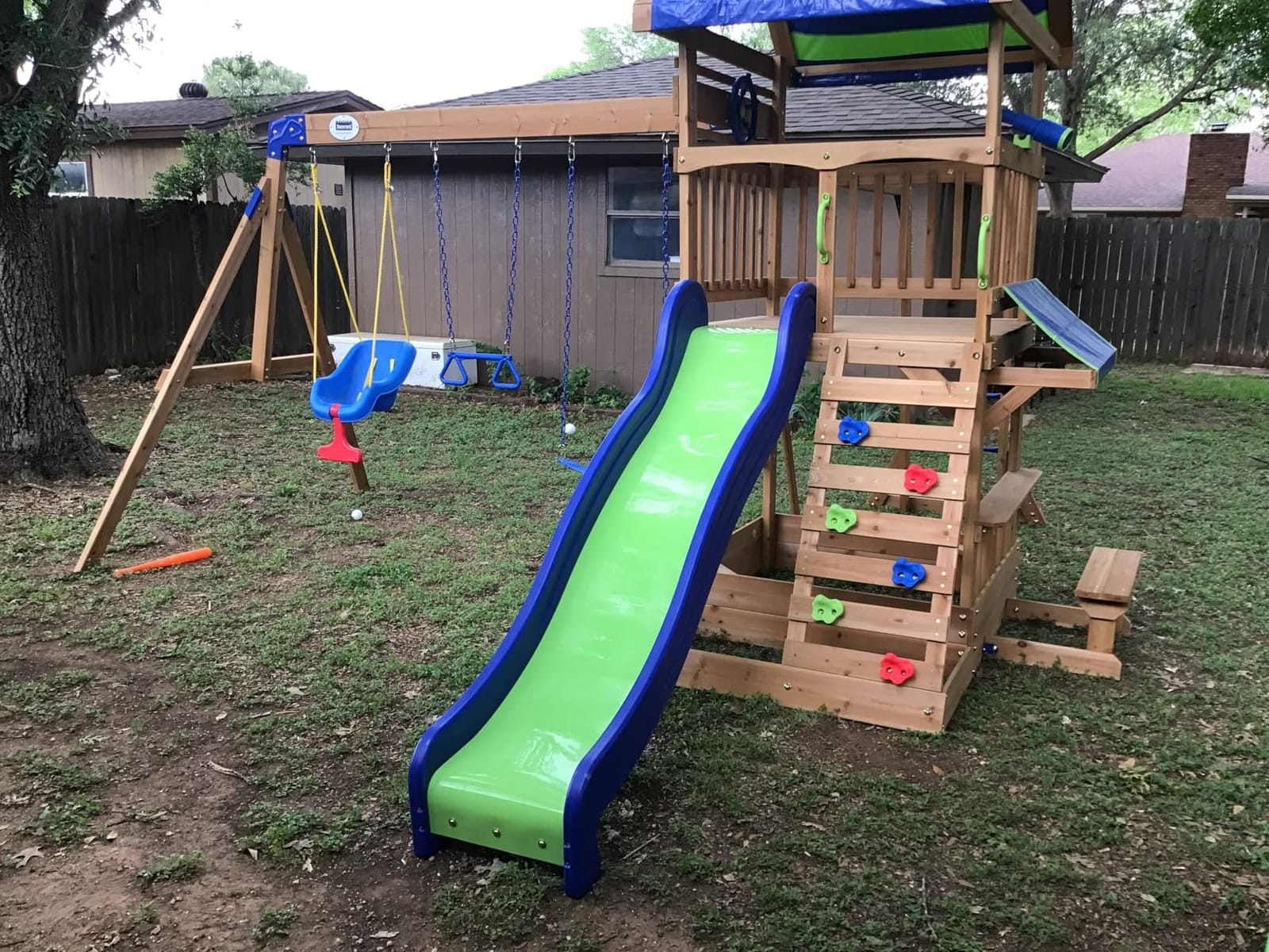 Backyard Discovery Beach Front Cedar Wood Swing Set with Wave Slide, Play Deck, Monkey Bars, Rock Wall Ladder, Shaded Picnic Area, Snack Bar, Belt Swings, Trapeze, Sandbox Area, Outdoor Playset customer photo 1